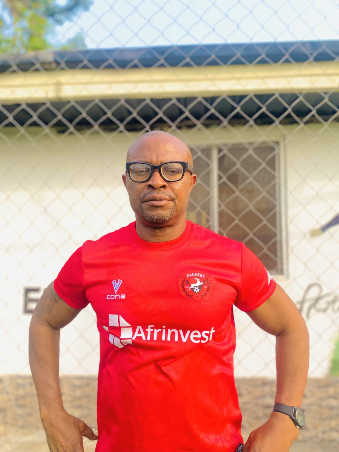 Football academy coach holding a ball